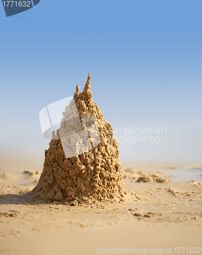 Image of Surreal sand castle on beach