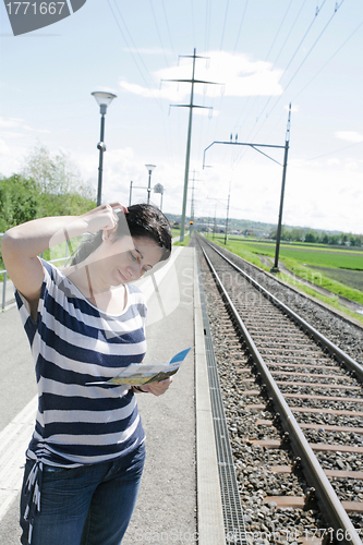 Image of Young woman confused on which direction to choose in a empty rai