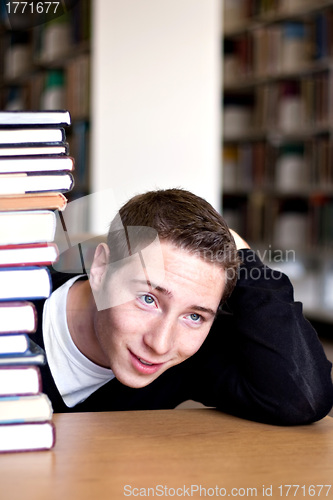 Image of Overwhelmed Student with Piled Books