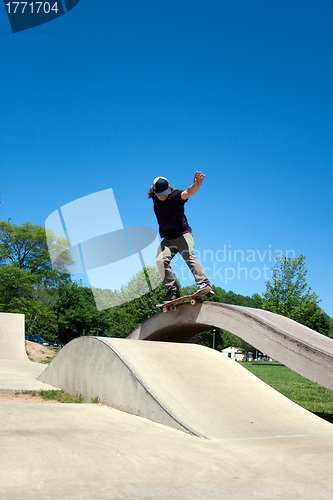 Image of Skateboarder Grinding at the Skate Park