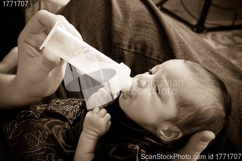 Image of Newborn Baby Drinking Formula Bottle