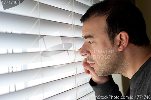 Image of Man Peeking Through Blinds