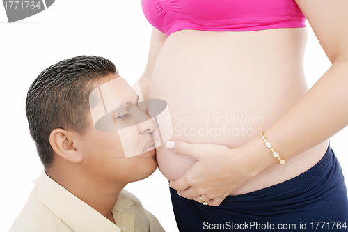 Image of Close up of a man kissing the belly of his lovely pregnant wife