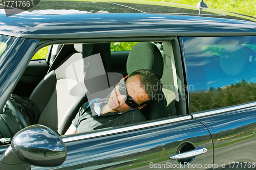 Image of man sleeps in a car 