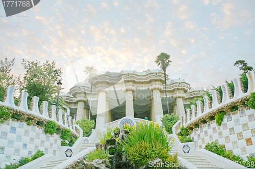 Image of Pavilion decorated with mosaic in Park Guell starting the sunset