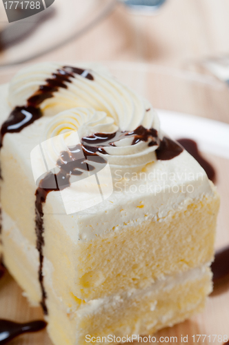Image of fresh cream cake closeup with chocolate sauce