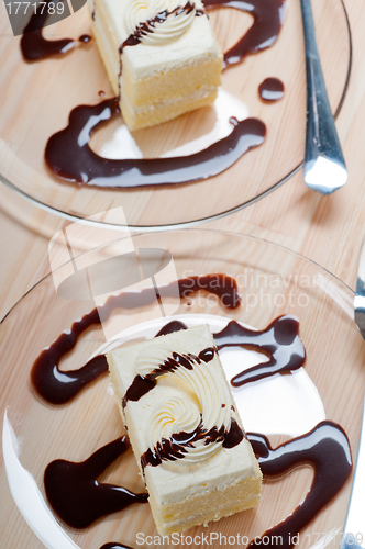 Image of fresh cream cake closeup with chocolate sauce