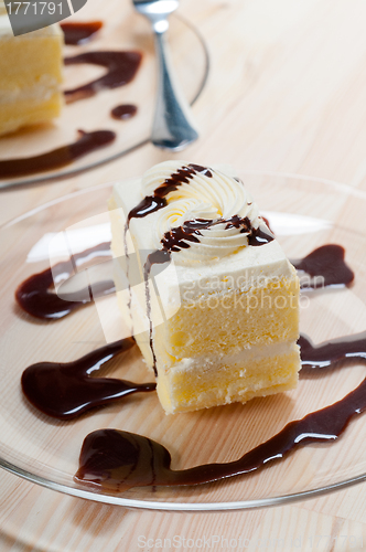 Image of fresh cream cake closeup with chocolate sauce