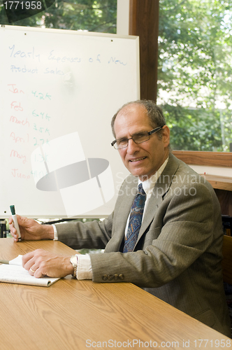Image of senior business executuve in conference office giving presentati