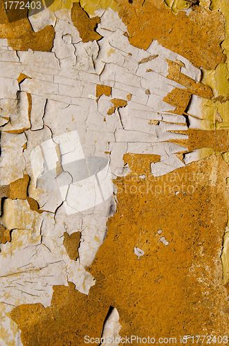 Image of Old painted wall losing paint. 