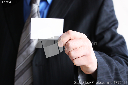 Image of Successful businessman holding empty card 