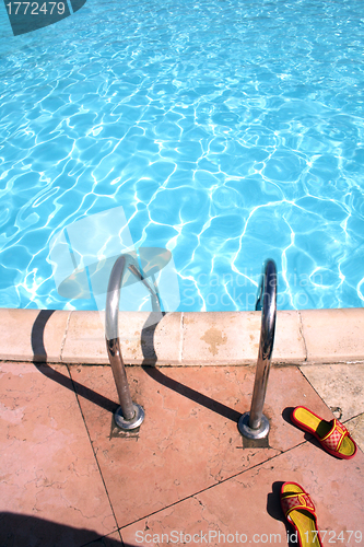 Image of flip-flops near the swimming pool