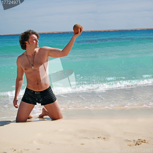 Image of Man posing with the coconut in hand
