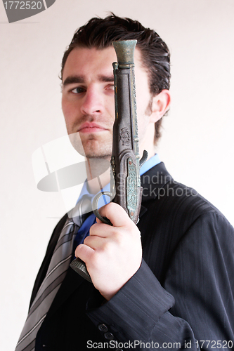 Image of Businessman with ancient weapon