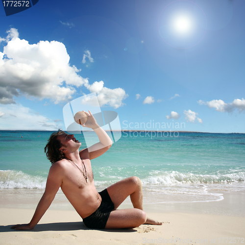 Image of man on the island with coconut