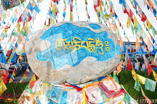 Image of Tibetan prayer flags and mani rock
