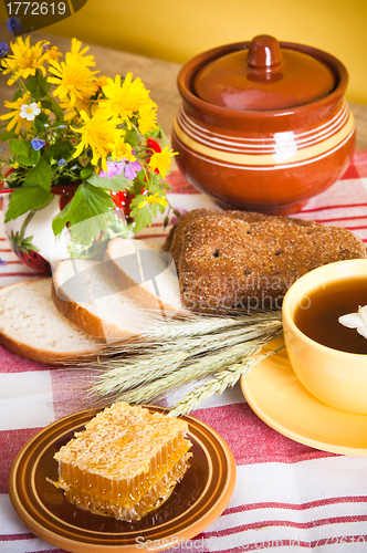 Image of Still life with honeycombs, flowers and pot 