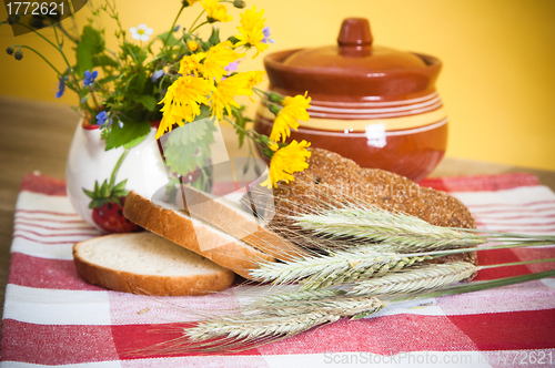 Image of Still life with bread, flowers and pot