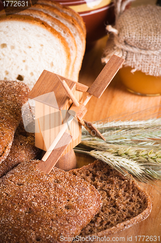 Image of sliced bread and wheat on the wooden table 