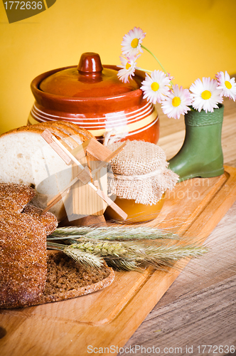 Image of sliced bread and wheat on the wooden table 