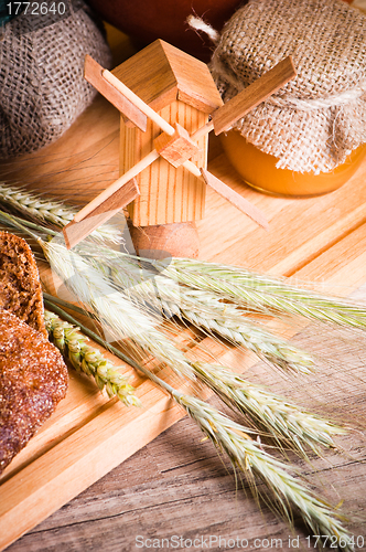 Image of sliced bread and wheat on the wooden table 