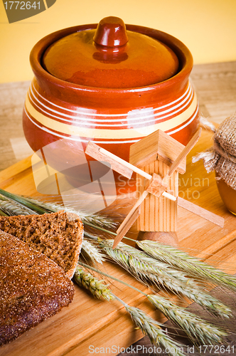 Image of sliced bread and wheat on the wooden table 