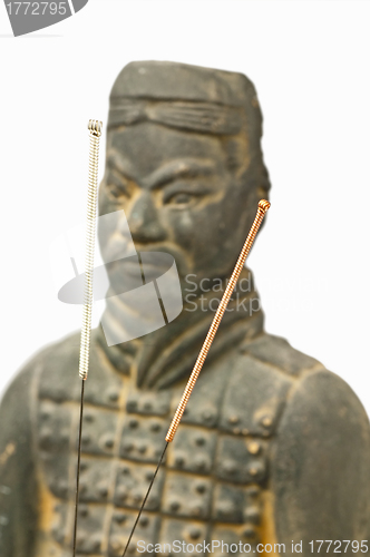 Image of acupuncture needles with chinese antique soldier