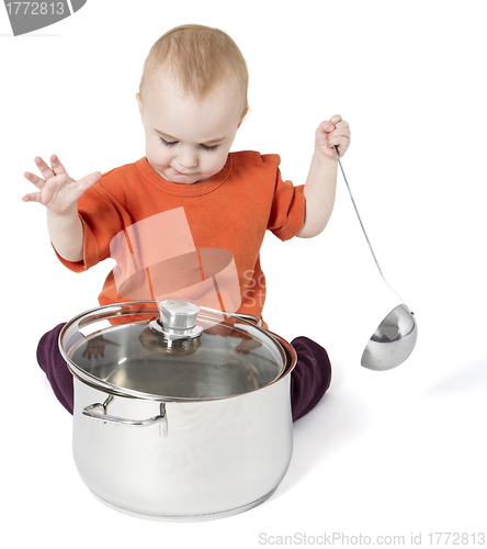 Image of baby with big cooking pot