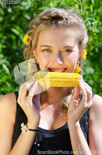 Image of woman eating corn-cob
