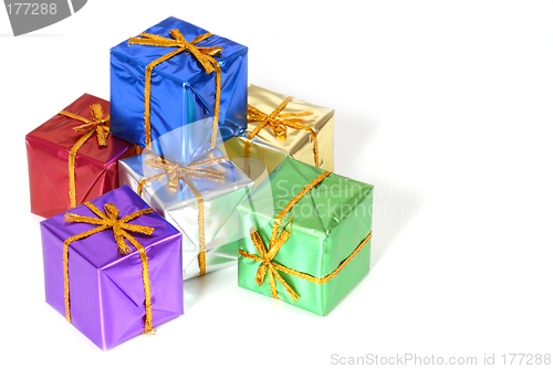 Image of Six brightly colored wrapped Christmas packages