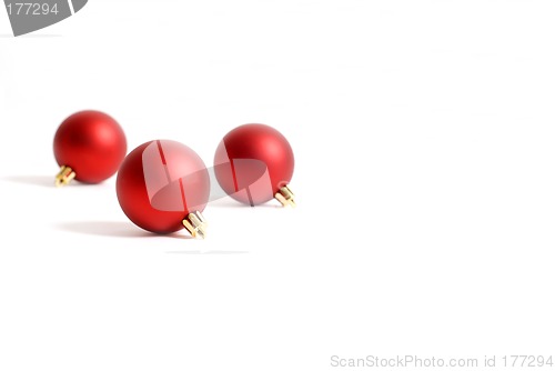 Image of Three round red Christmas ornaments