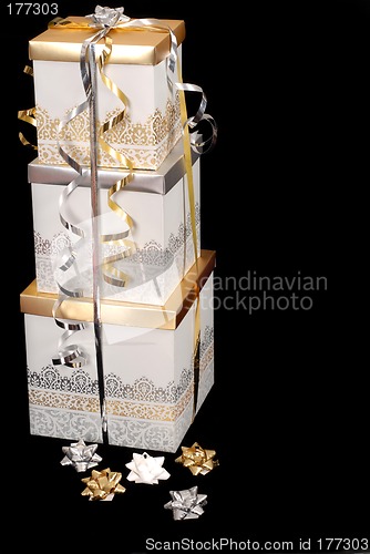Image of Three silver and gold wrapped Christmas presents with bows