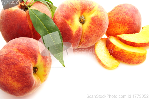 Image of  Fruits of peach with green leaves.