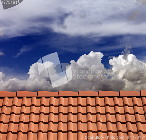 Image of Roof tiles and blue sky with clouds