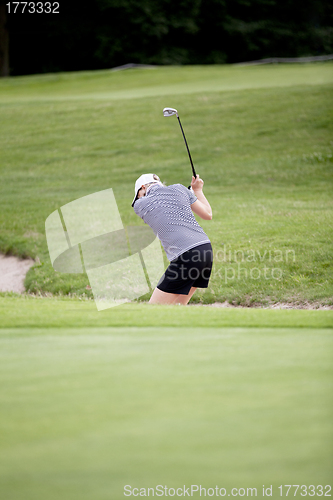 Image of woman is playing golf on course  summer