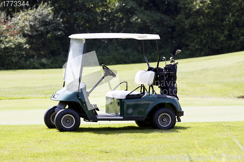 Image of golf car on a course in summer