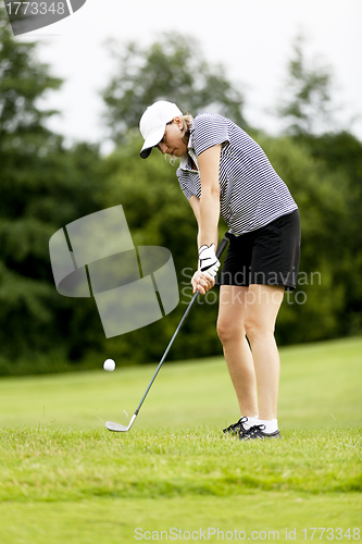 Image of woman is playing golf on course  summer