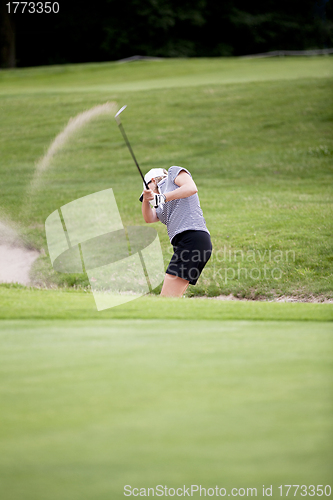 Image of woman is playing golf on course  summer