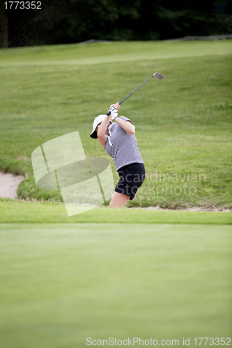 Image of woman is playing golf on course  summer