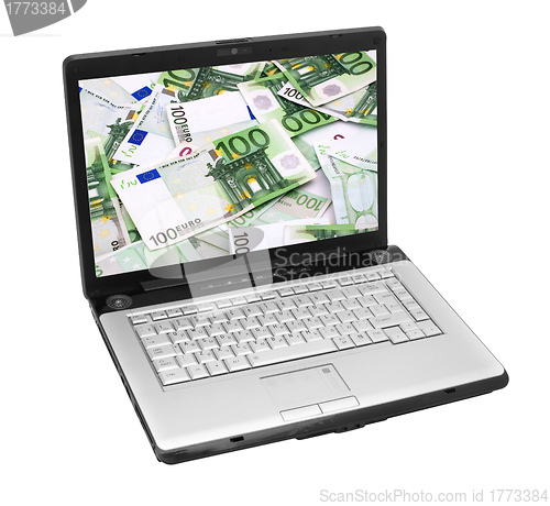 Image of Open laptop with money 