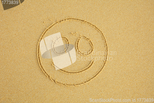 Image of Smiling face on sand