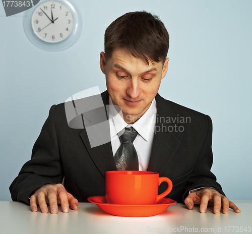 Image of Businessman drinking a very strong and  hot coffee