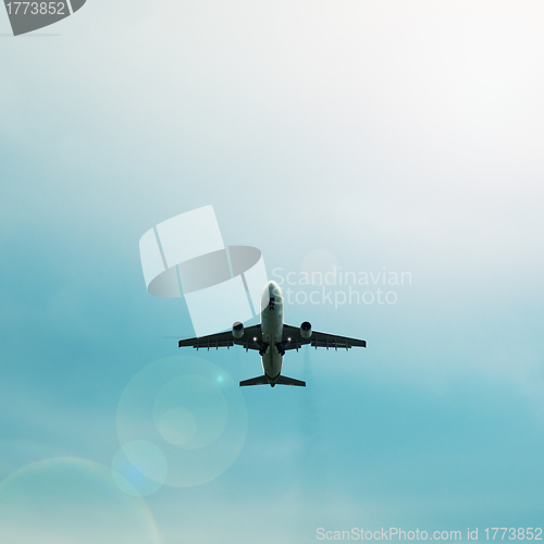 Image of Silhouette of passenger airplane flying in the sky