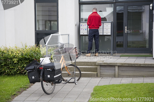 Image of Postman distributing