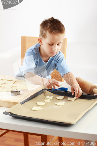 Image of Small boy baking cookies