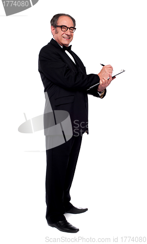 Image of Full length shot of man writing on clipboard