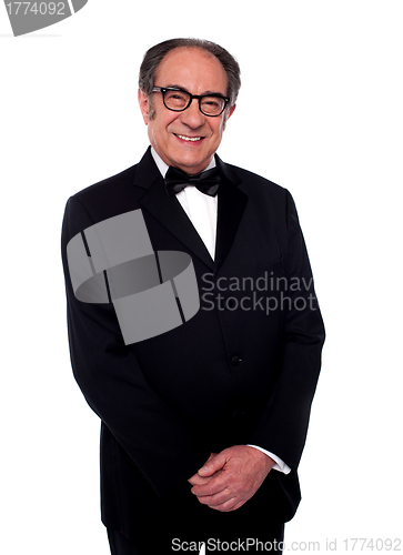 Image of Well dressed smiling senior male posing