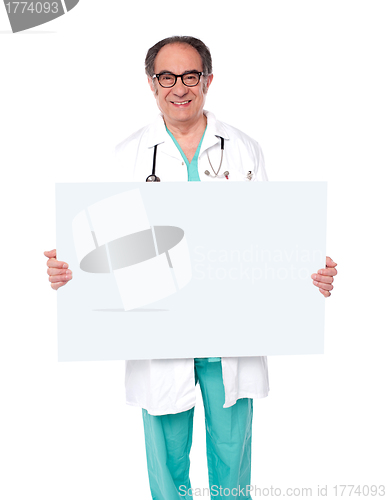 Image of Male doctor posing with white blank billboard