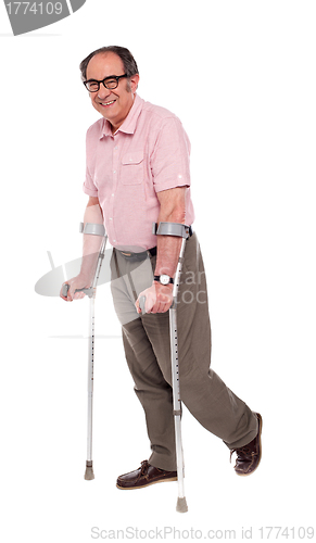 Image of Smiling elderly man with crutches