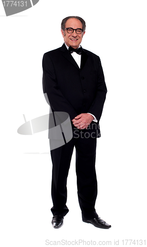 Image of Attractive senior man posing in tuxedo